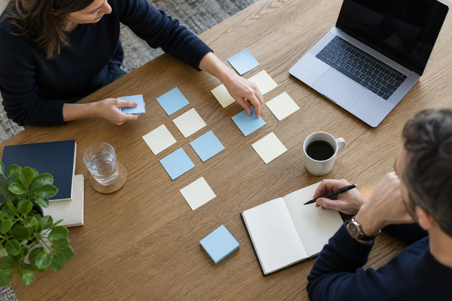 Illustrative scene of a workflow planning session with notes and a laptop